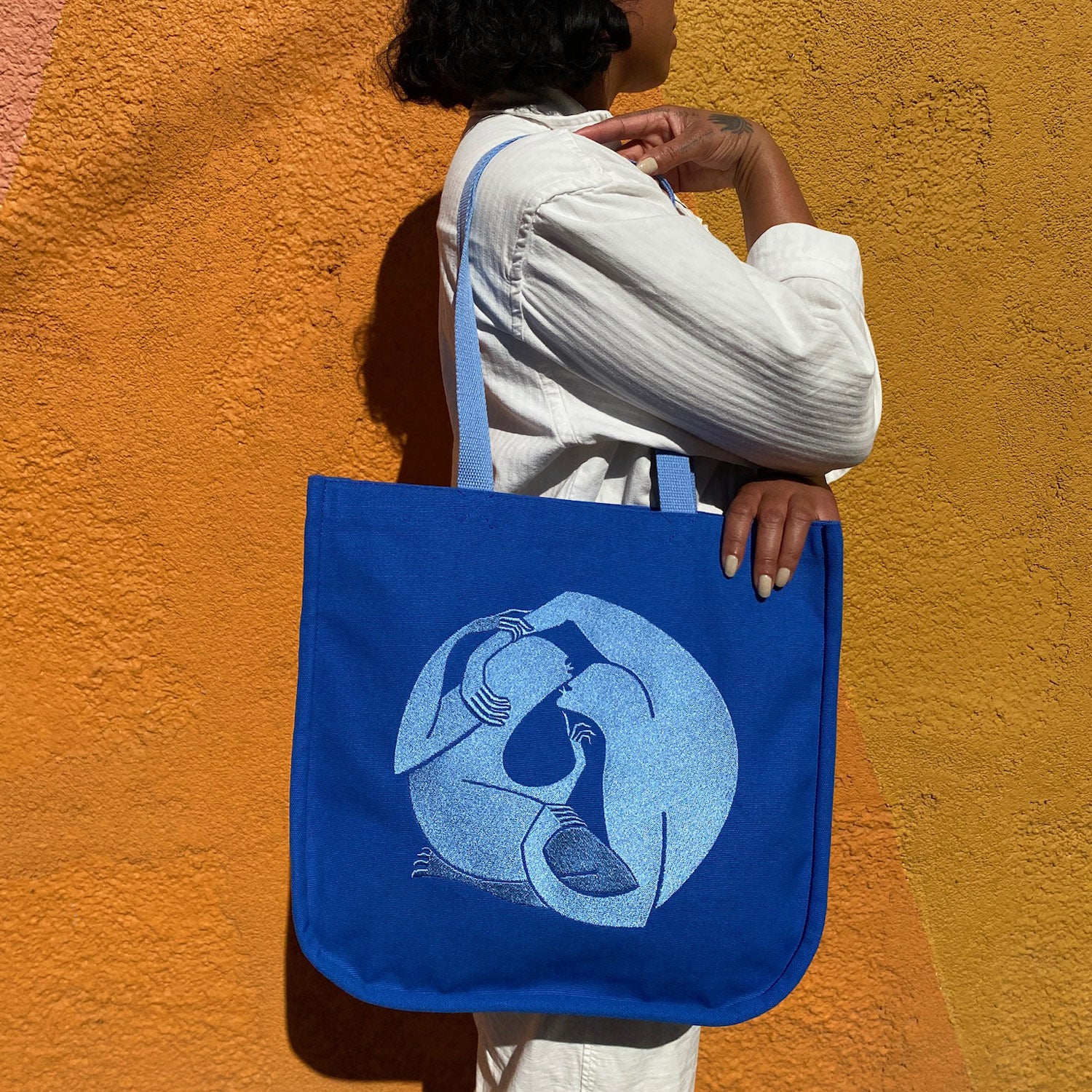 https://animalhandmade.com/cdn/shop/files/canvas_tote_blue_embroidery_lifestyle_1500x.jpg?v=1698192494